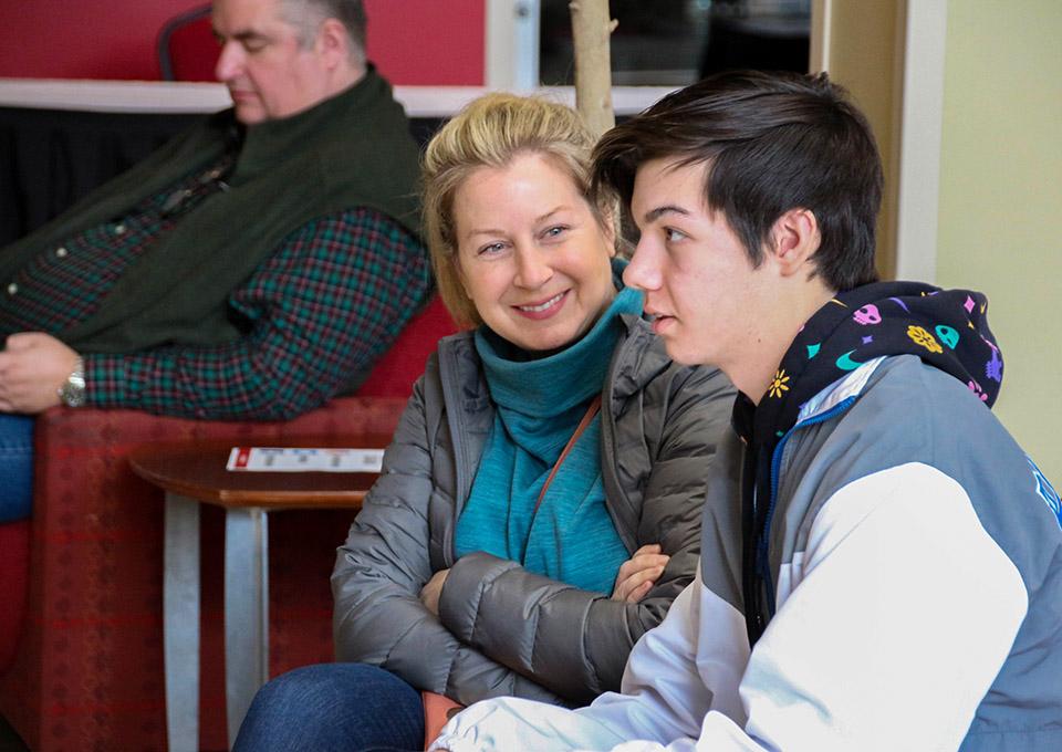 mom and son at open house, mom looks at son expectantly